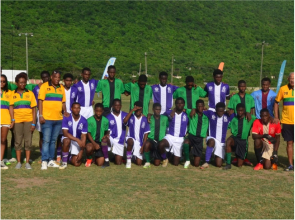 A group of young men standing on top of a soccer field.