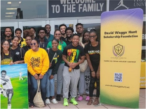A group of people standing in front of some signs.