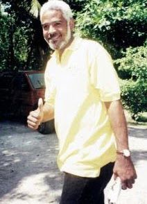 A man in yellow shirt giving thumbs up.